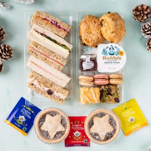 Traditional festive afternoon tea hamper with cakes, tea and sandwiches